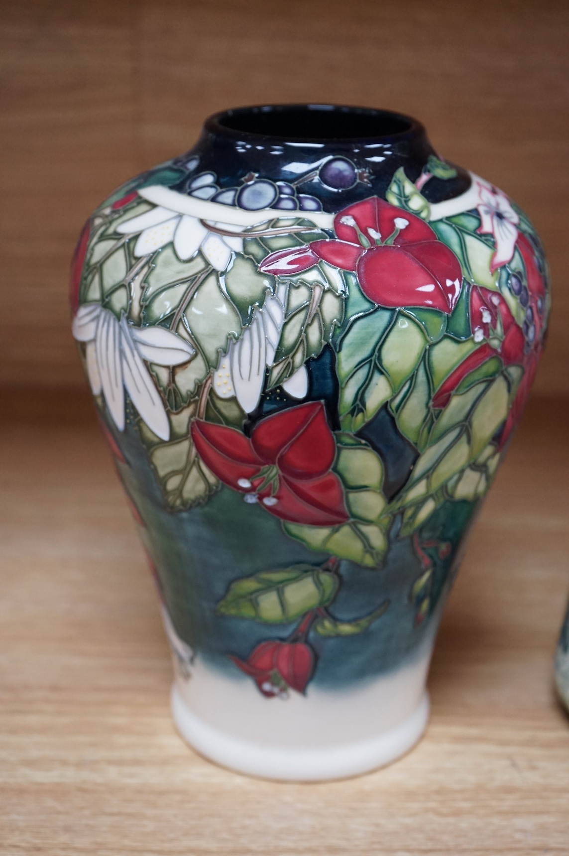 A Moorcroft ‘Nostalgia’ pattern vase together with a similar ‘Foxglove’ pattern ewer, 24.5cm. Condition - good, some crazing